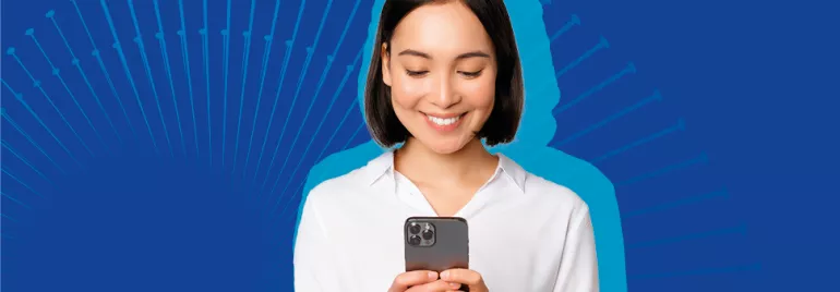 Persona sorridente guarda lo smartphone su sfondo blu.